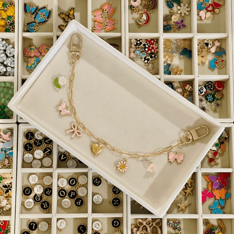 A jewelry-making tray with beads and findings sorted into compartments